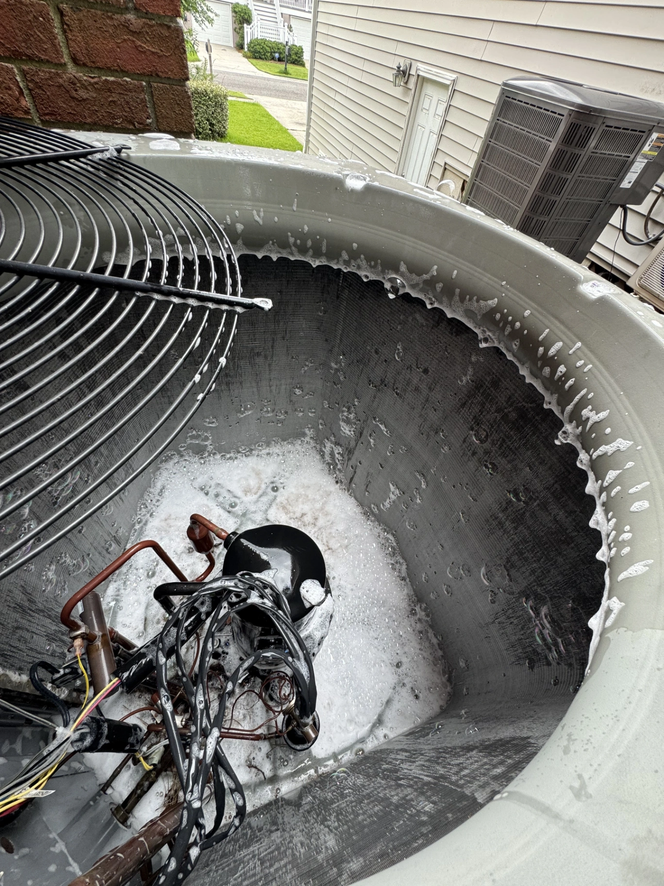 Maximum Air Experts technician performing AC maintenance on outdoor unit in North Charleston